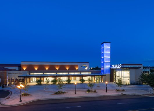 Pueblo Convention Center exterior at nighttime featuring blue backlighting on building tower with Kalwall facade.