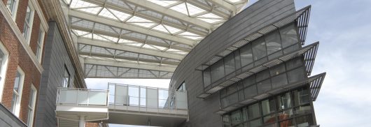 University of Cincinnati Student Life Center featuring two buildings attached by walkway with Kalwall canopy above